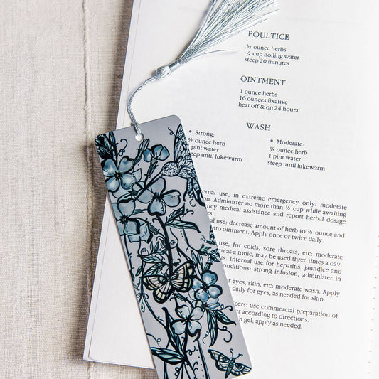 metal bookmark with flue flowers and a botanical figure with butterflies by Marcy Ellis..
