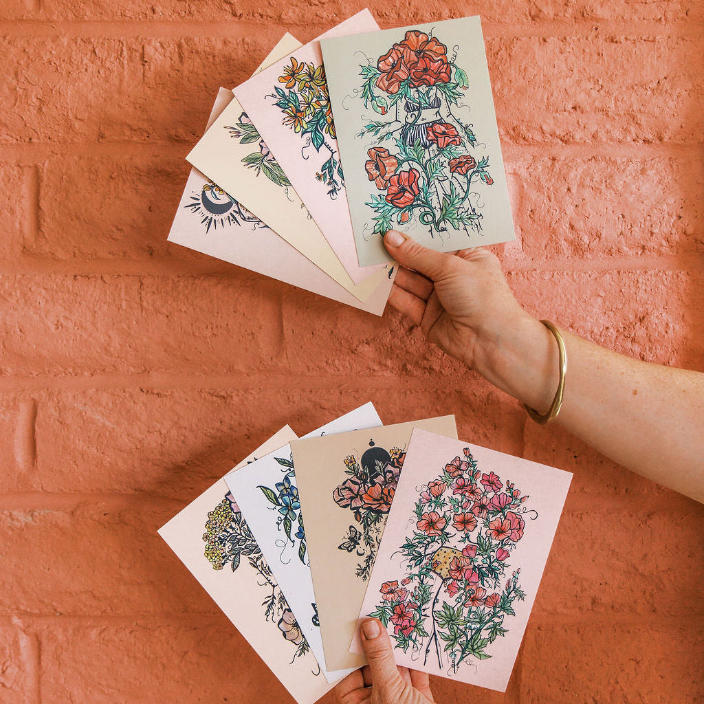 the complete flora sisters collection — feminine botanical figures in watercolor across prints, stickers, cards, apparel & more. sisterhood art by tucson artist marcy ellis.