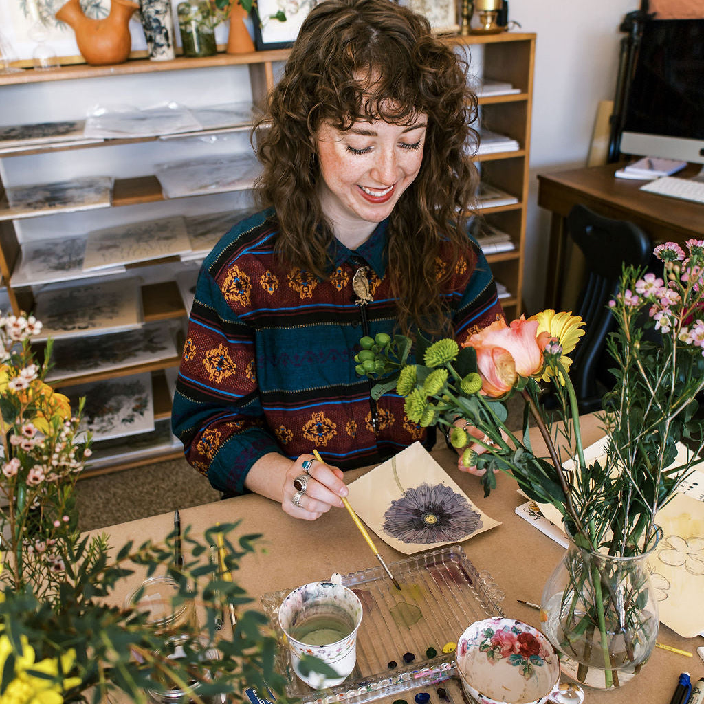 woman painting botanicals at a Marcy Ellis workshop tucson az
