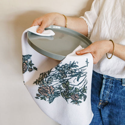 botanical feminine white waffle weave dish towel by Marcy Ellis drying a plate. 