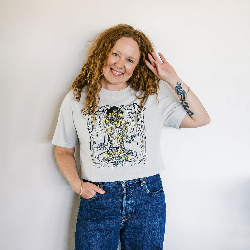 Marcy Ellis wearing monsoon caller screen printed crop tee with creosote flowers and desert rain clouds by marcy ellis