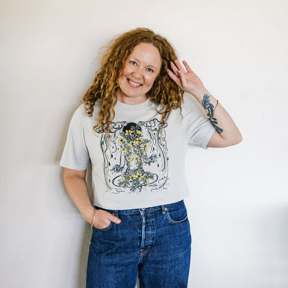 Marcy Ellis wearing monsoon caller screen printed crop tee with creosote flowers and desert rain clouds by marcy ellis