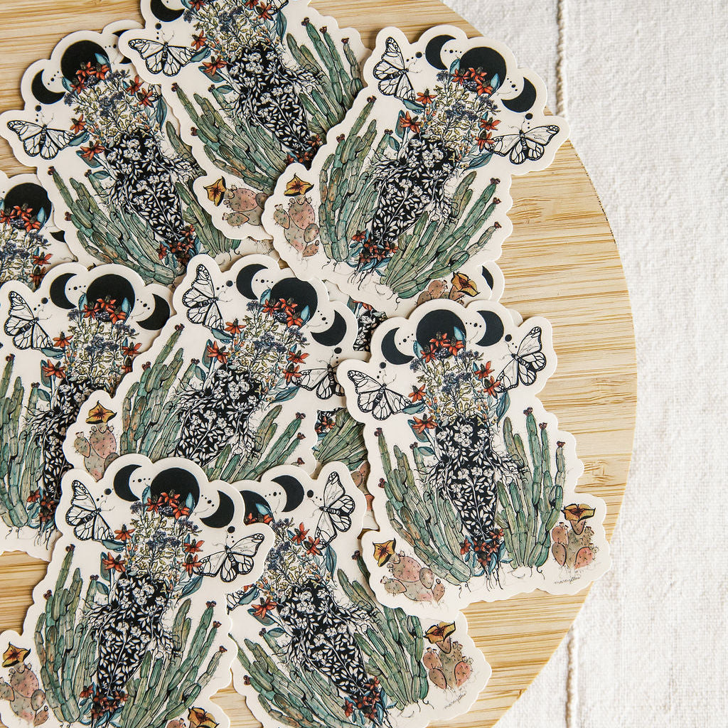hand-painted watercolor sticker of a feminine figure blooming with desert cacti and a lunar phase. waterproof matte vinyl, designed by tucson artist marcy ellis. a gift for your sister in spirit.