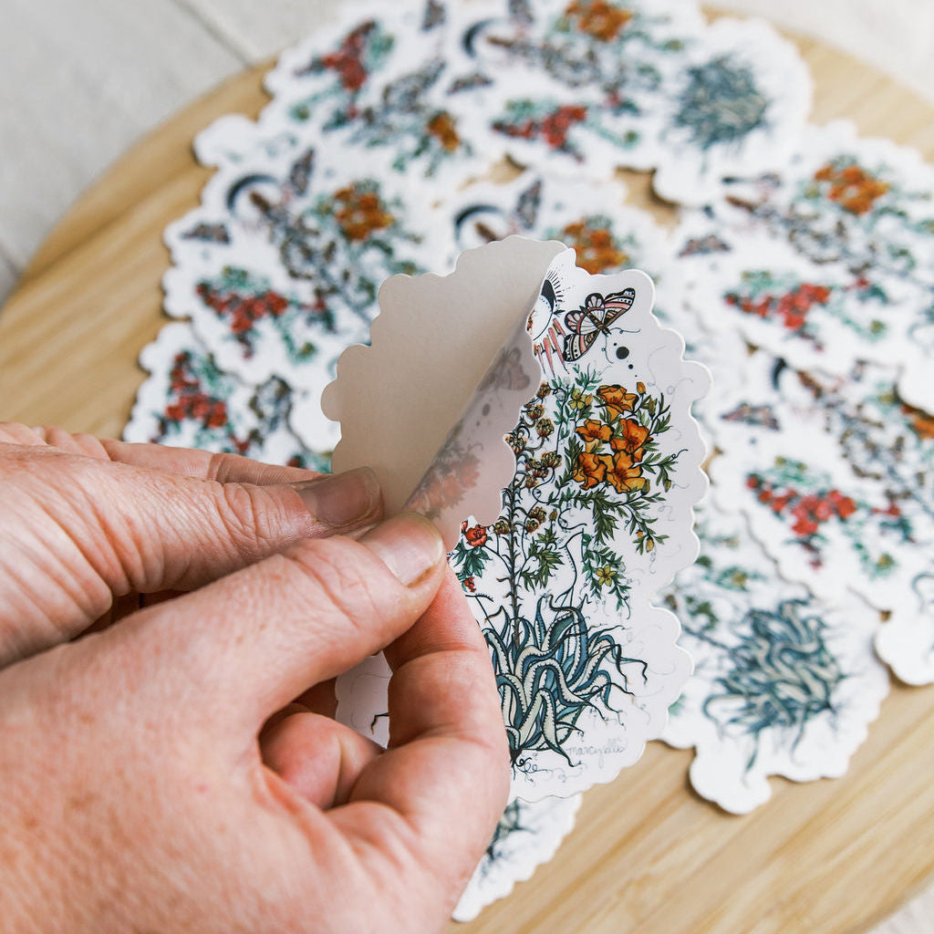 hand-painted watercolor sticker of two feminine figures blooming beside an agave plant. waterproof matte vinyl, designed by tucson artist marcy ellis. a gift for your sister in spirit.