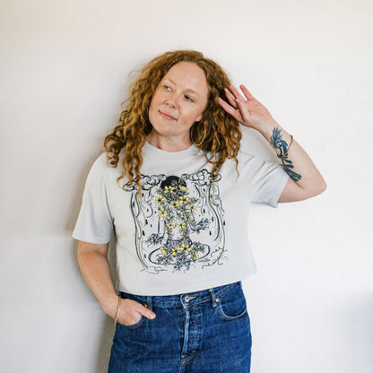 Marcy Ellis wearing monsoon caller screen printed crop tee with creosote flowers and desert rain clouds by marcy ellis