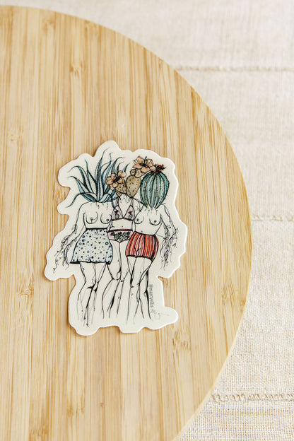 Sticker of two people with plants on a wooden surface
