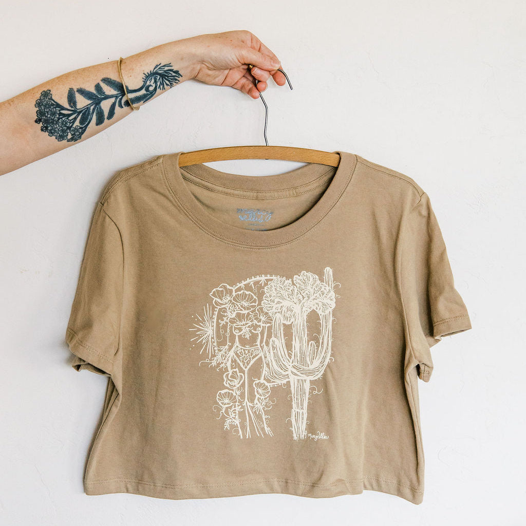 sand boxy crop tee hand screen printed with an ivory crested saguaro and botanical figure design by marcy ellis