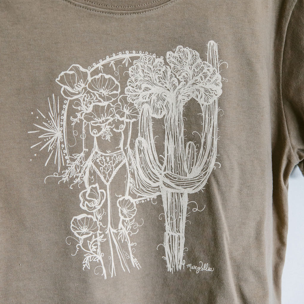 close up detail of a sand boxy crop tee hand screen printed with an ivory crested saguaro and botanical figure design by marcy ellis