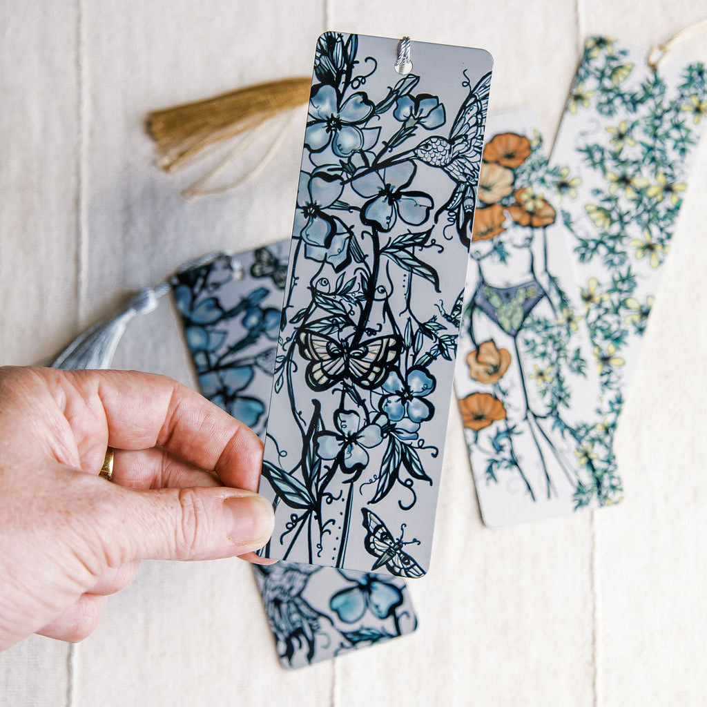 metal bookmark of floral figure and hummingbird by Marcy Ellis. 
