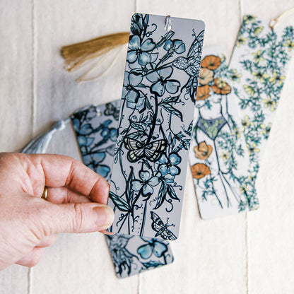 metal bookmark of floral figure and hummingbird by Marcy Ellis. 