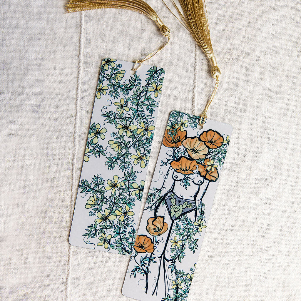 front and back of a metal bookmark with desert botanical figures and creosote bu Marcy Ellis. 