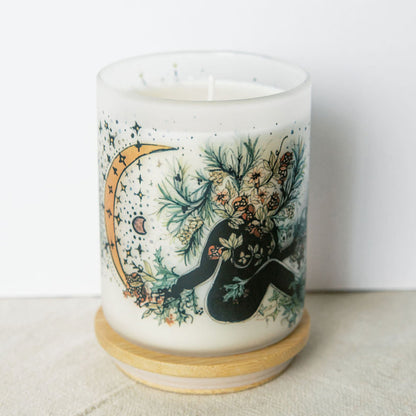 yule winter solstice soy candle with botanical artwork wrapped around frosted glass jar