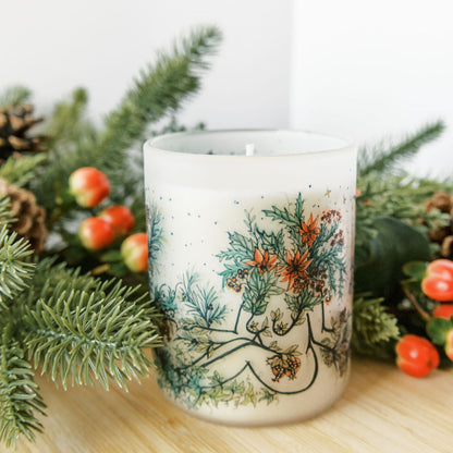yule winter solstice soy candle with botanical artwork wrapped around frosted glass jar