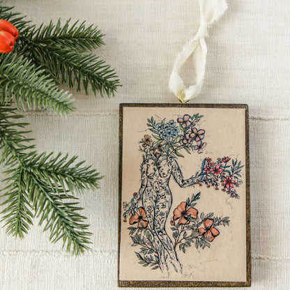 offerings of love is a wooden holiday ornament, botanical artwork on dark stained wood with gold eye screw and ribbon