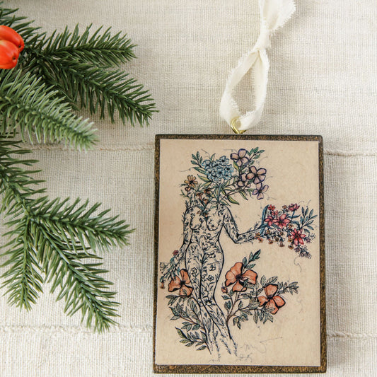 offerings of love is a wooden holiday ornament, botanical artwork on dark stained wood with gold eye screw and ribbon