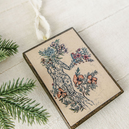 offerings of love wooden holiday ornament, botanical artwork on dark stained wood with gold eye screw and ribbon
