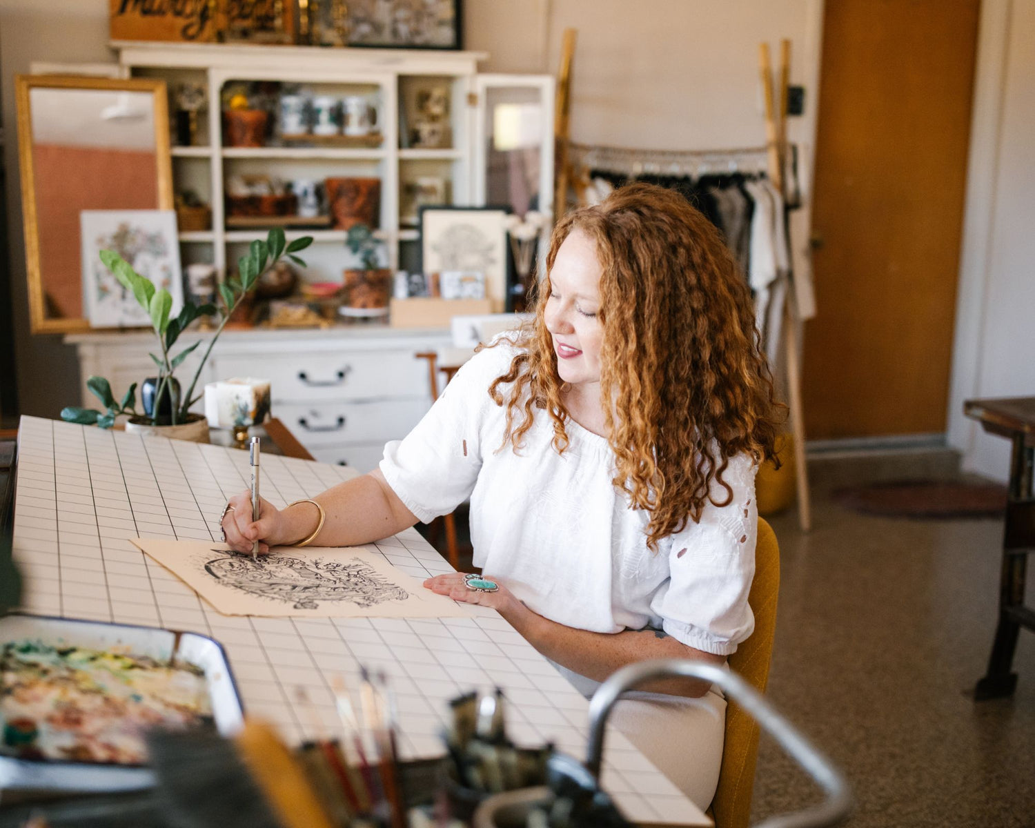 marcy ellis drawing a botanical figure in her tucson studio 