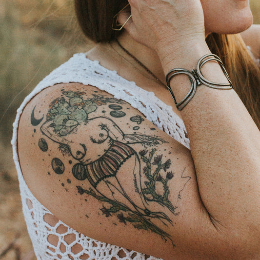 fine line color tattoo of a female plant lady botanical figures by marcy ellis on upper arm.